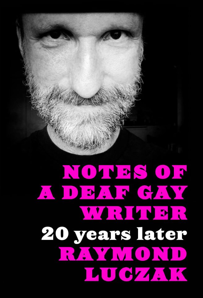 The black-and-white shot shows a bearded man smiling quietly and directly at us. Below his face is the text in hot pink and white: NOTES OF A DEAF GAY WRITER | 20 years later | RAYMOND LUCZAK.